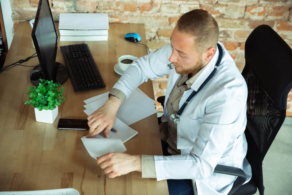 crohns doctor sitting in front of monitor