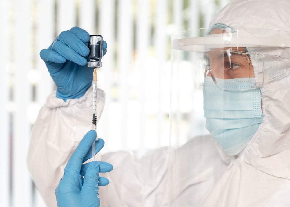 A doctor preparing injection for infusion safety monitoring delaware patients
