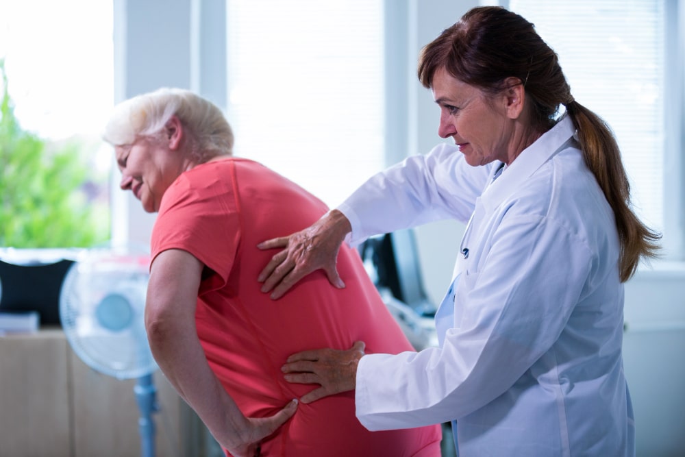 Female doctor examining a patient for osteoporosis screening milford delaware