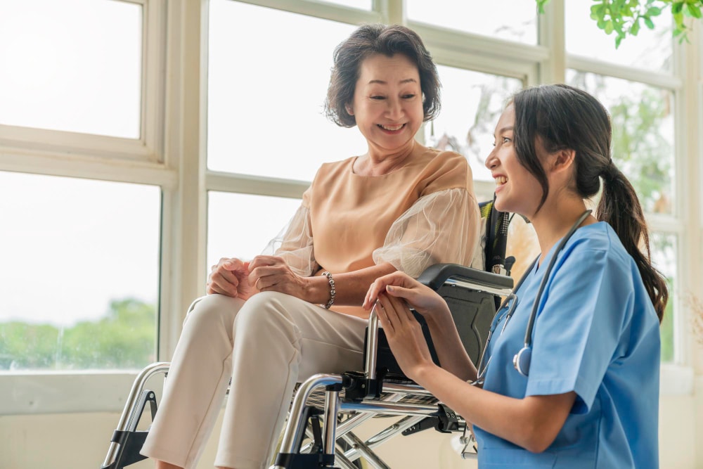 Nurse assisting a senior woman in a wheelchair, highlighting geriatric care Wilmington Delaware.