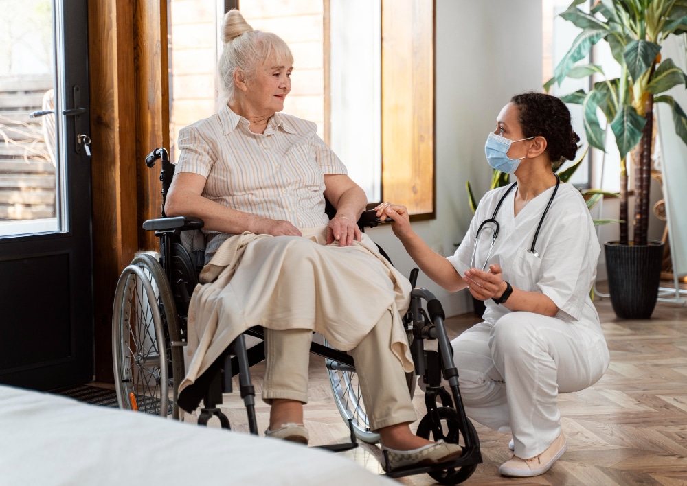 Nurse assisting elderly woman in wheelchair at home, geriatric care delaware.