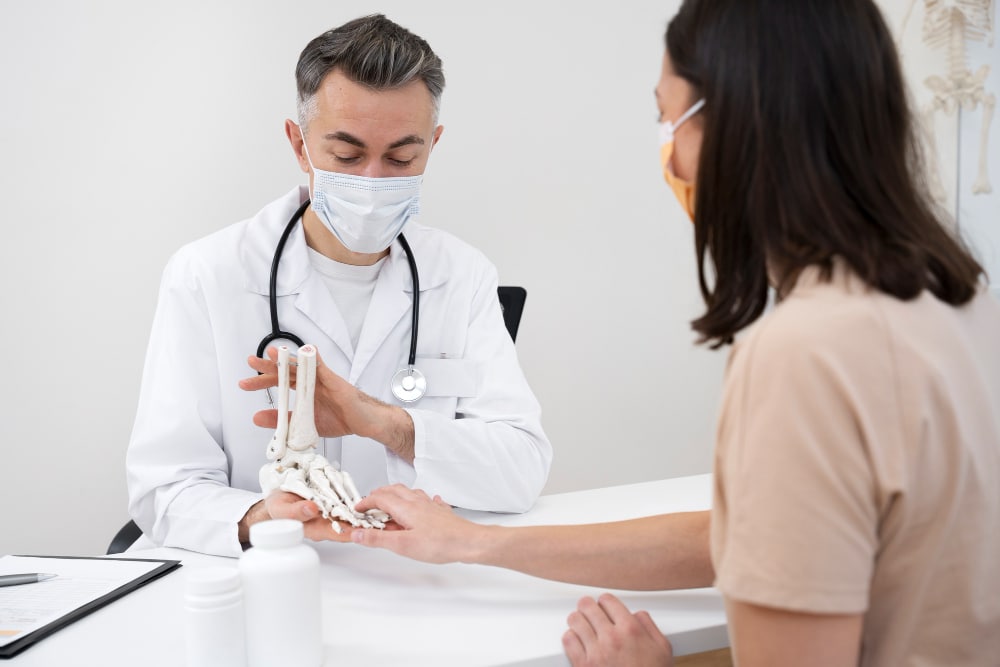 Doctor explaining foot joint anatomy during a Rheumatology Consultation Wilmington Delaware.